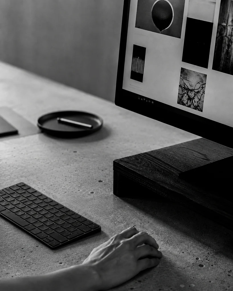 Detalhe da mesa de trabalho com referências visuais na tela